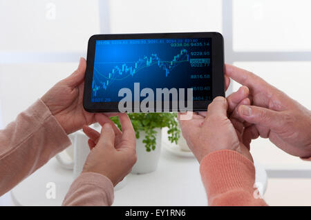 Senior couple's hands holding touch pad, Stock Photo