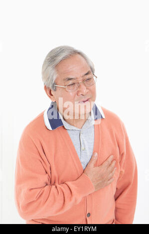 Senior man having chest pain and looking away, Stock Photo