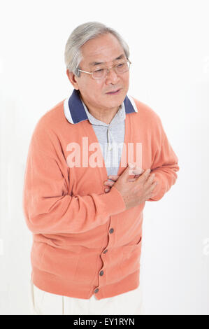 Senior man having chest pain and looking away, Stock Photo