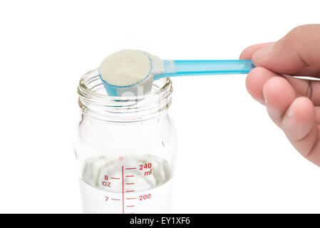 putting powdered milk into a baby bottle close up with clipping path Stock Photo