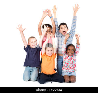 Group of children posing with raised hands isolated in white Stock Photo