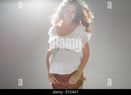 Studio portrait of pregnant young woman Stock Photo
