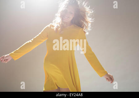 Studio portrait of pregnant young woman twirling around Stock Photo