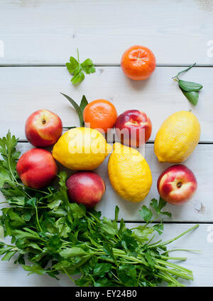 Bunch of parsley with lemons, nectarines and tangerines Stock Photo