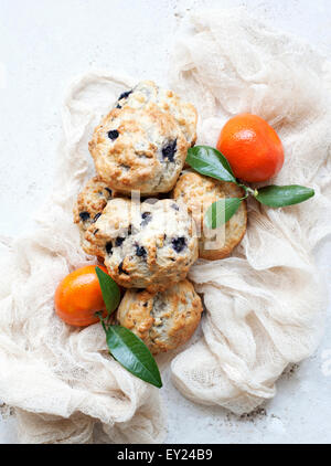 Still life of blueberry scones with tangerines Stock Photo