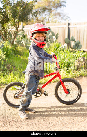 Boy with a bicycle, wearing helmet Stock Photo