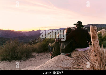 Rear view of three adult friends looking out on landscape, Los Angeles, California, USA Stock Photo