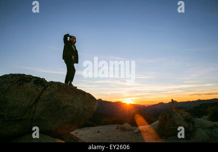 Young man looking out on landscape at sunset, Los Angeles, California, USA Stock Photo