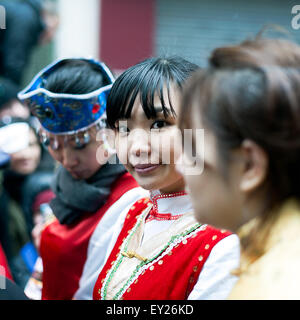 Paris, France - Feb 10, 2013: Chinese young girls performs in traditional costumes at the chinese lunar new year parade. Stock Photo