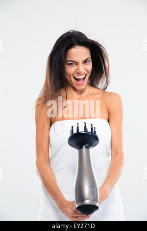 Funny laughing woman in towel drying her hair isolated on a white background Stock Photo