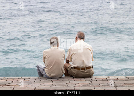 Two elderly Spanish men looking out to sea Stock Photo