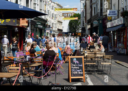 East Street in Brighton with people drinking coffee at pavement cafes on Summer weekend Stock Photo