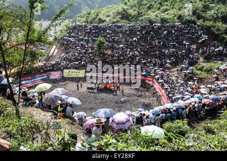 Jianhe, China's Guizhou Province. 20th July, 2015. Thousands of audience come to watch the bull fight in Jianhe County, southwest China's Guizhou Province, July 20, 2015. A Bull King Competition held in the county attracted many audience from the neighboring villages. This competition was part of the Guizhou Jianhe Yangasha Culture Festival in 2015, which was held to commemorate Yangasha, a beautiful lady symbolizing love and life in the legend of Miao ethnic group. © Liu Xu/Xinhua/Alamy Live News Stock Photo
