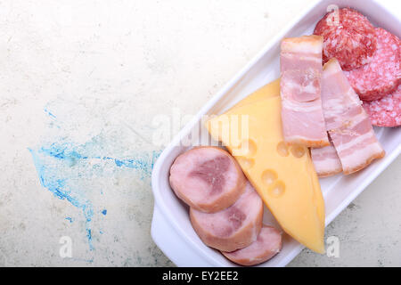 Pepperoni Salami and cheese on a cutting board Stock Photo