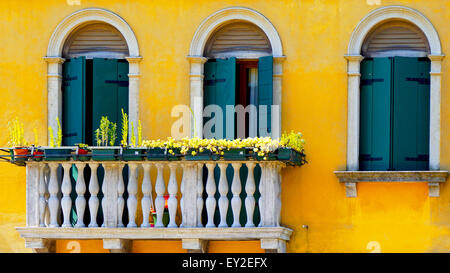 two Doors and terrace in Burano on yellow color wall building architecture,Venice, Italy Stock Photo