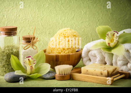Spa still life with salt,towel,sponge,handmade soap and blooming orchid Stock Photo