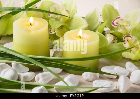 Spa still life with candles,pebble stones and orchid Stock Photo