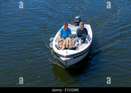 Two men in a small outboard-powered boat on a lake Stock Photo - Alamy