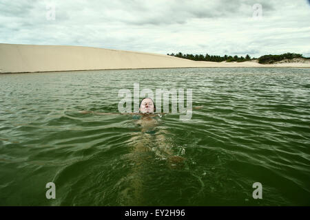 woman swimming in a paradise among dunes in Preá Beach, Jericoacoara, Ceará, Brazil Stock Photo