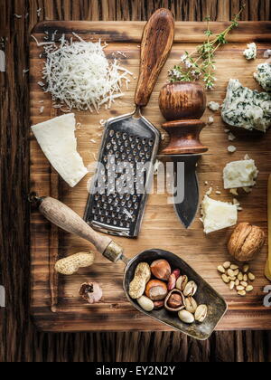 Different types of cheeses with nuts and herbs. Top view. Stock Photo