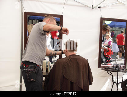 Outdoor hairdressers cutting hair on street outside KFC ...