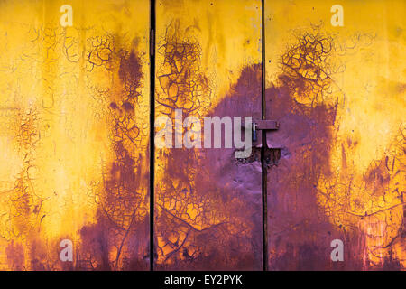 old paint horizontal door background yellow and purple colors with crack and scratch Stock Photo