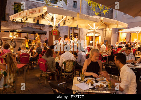 Locals and tourists eating at a restaurant outside at night, Barceloneta, Barcelona, Spain Europe Stock Photo