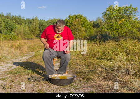 Old man fishing thinking he's still a kid Stock Photo