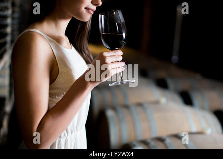 Young woman in the wine cellar Stock Photo