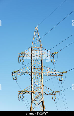 Supports for high-voltage power line against the blue sky. Stock Photo