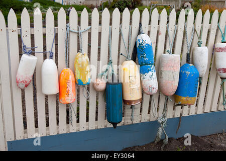 Fishing buoys hanging on a white picket fence, Point Montara Light Station, Montara, California, United States of America Stock Photo