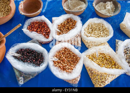 Display of different types of maiz, large-kernel corn grown in Peru, along with some ground into flour. Stock Photo