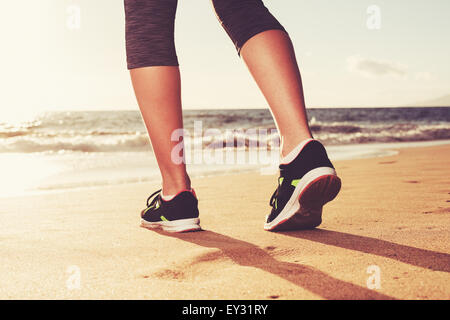Close up of runner's feet at Sunset. Fitness woman, workout wellness lifestyle concept. Stock Photo