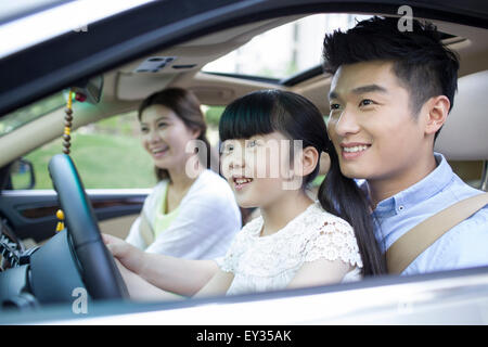 Happy young family in a car Stock Photo