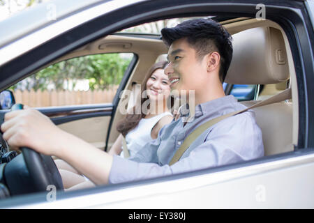Happy young couple in a car Stock Photo