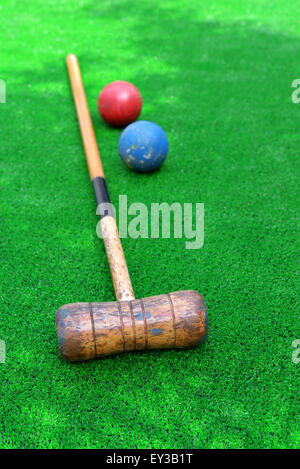 Croquet equipment on artificial grass , mallet and balls Stock Photo