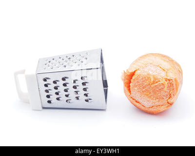 grater and carrots on a white background Stock Photo