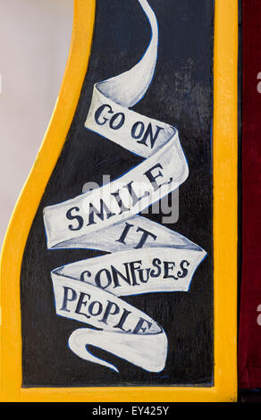 Go on smile it confuses people sign on a Punch and Judy Show stage at the Thames Boat Festival, Henley On Thames, Oxfordshire, England Stock Photo