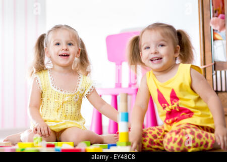 Kids playing with wooden blocks Stock Photo