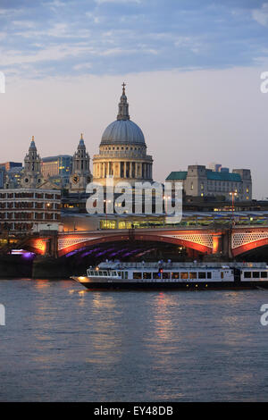 Blackfriars Railway Bridge, in front of St Paul's Cathedral, across the River Thames, at dusk, in London, UK Stock Photo