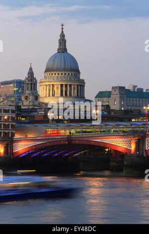 Blackfriars Railway Bridge, in front of St Paul's Cathedral, across the River Thames, at dusk, in London, UK Stock Photo