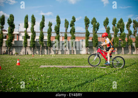 Boy Riding Mountain Bike Through Obstacle Course Stock Photo