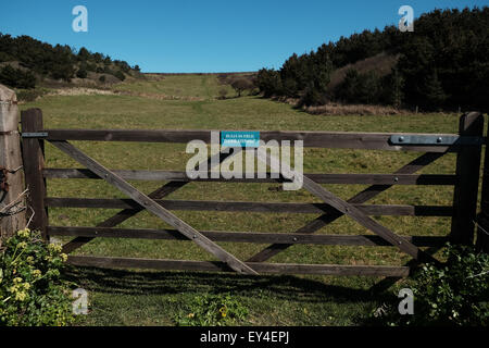 Beware of the bull sign on country fence Stock Photo