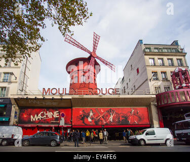 Paris, France - October 9, 2014: Street view of historic Moulin Rouge in Paris France with people and cars visible. Stock Photo