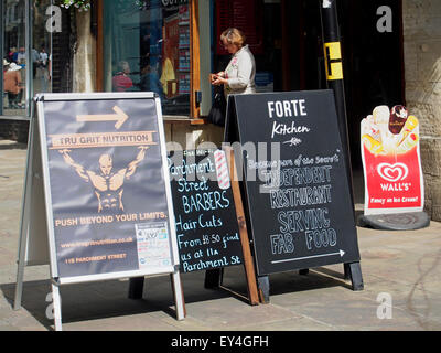 A-boards in Winchester High Street advertising small speciality stores in an adjacent side street. Stock Photo