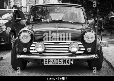 Quenza, France - July 1, 2015: Black Mini cooper car stands parked, closeup photo, front view Stock Photo