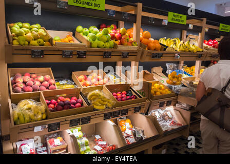 Paris, France, Woman at Fresh Fruits on Display Luxury Food Shopping in French Department Store, Le Bon Marché, La Grande Épicerie De Paris, neighborhood grocery store vegetables, greengrocer inside Stock Photo