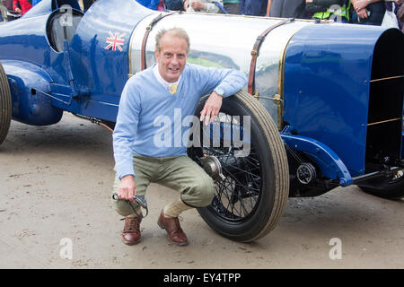 Pendine Beach, Carmarthen, Wales, UK. 21st July, 2015. Don Wales, Sir Malcolm Campbell’s grandson, posing by the Sunbeam Blue Bird racing car. 2015 celebrates the 90th anniversary of Sir Malcolm Campbell achieving a new World Land Speed record of 150mph at Pendine Sands, South Wales, in his 350hp Sunbeam. Credit:  Daniel Valla FRPS/Alamy Live News Stock Photo