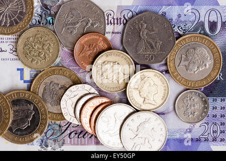 British £1 and £2 coins on a £5 note Stock Photo - Alamy