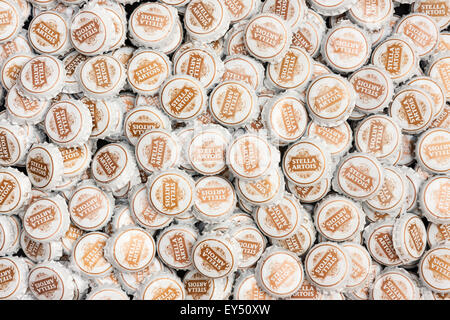 Pile of Stella Artois disregarded used beer bottle tops, Stella Artois logo in gold on each top. Stock Photo